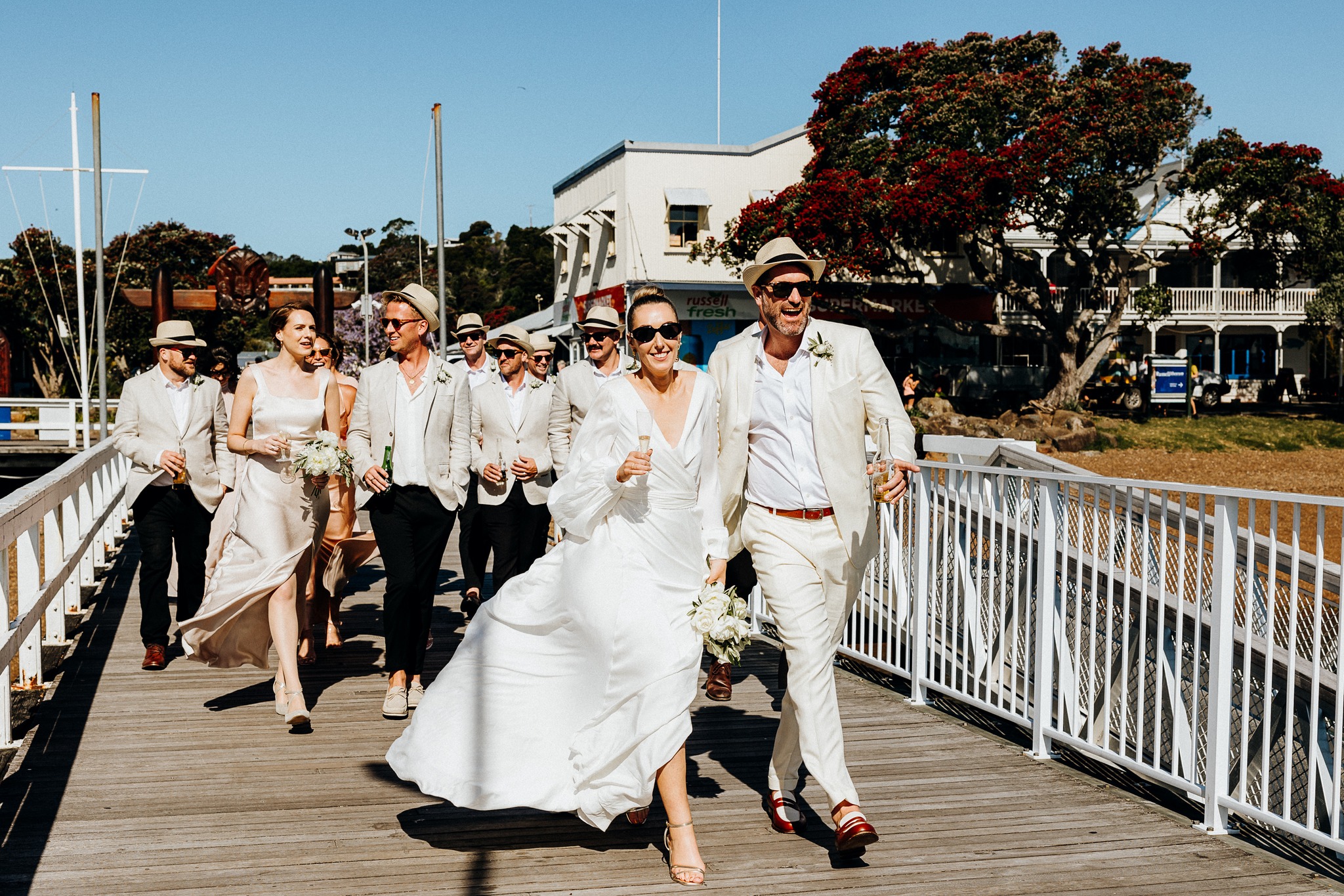 Bride and groom walking along the waterfront in Russell